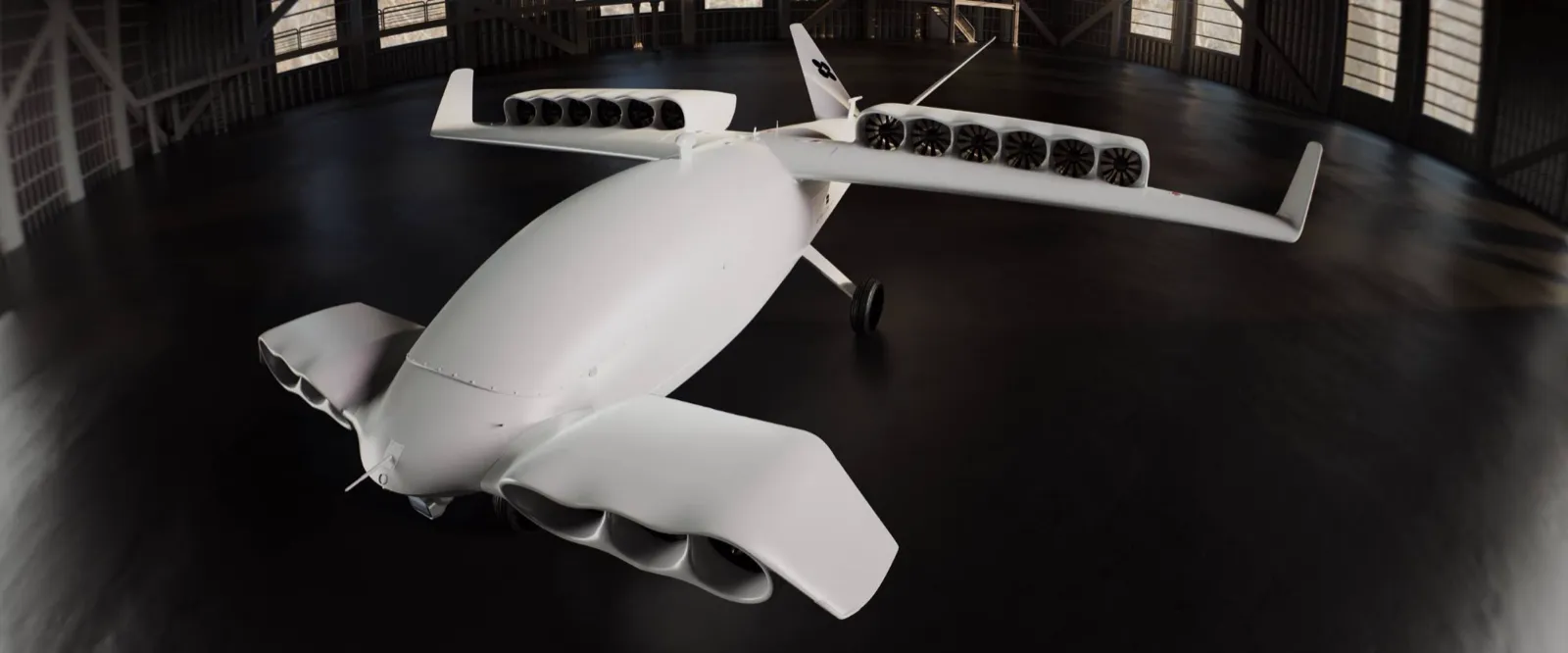 White eVTOL with rows of wing fans in a dark hangar