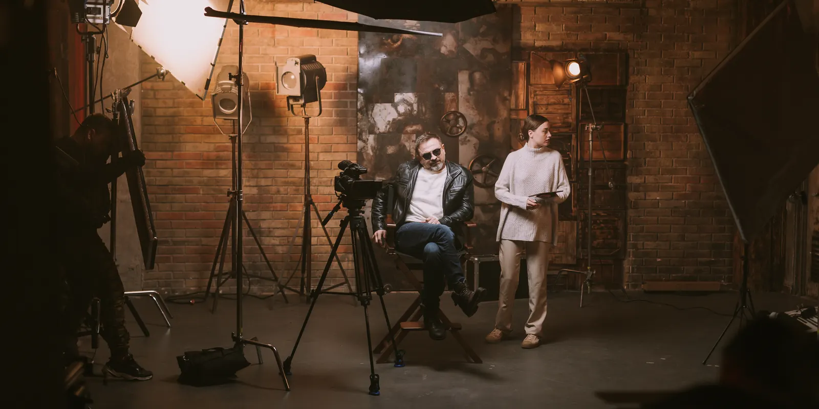 Studio set with lights, softboxes, camera and cast