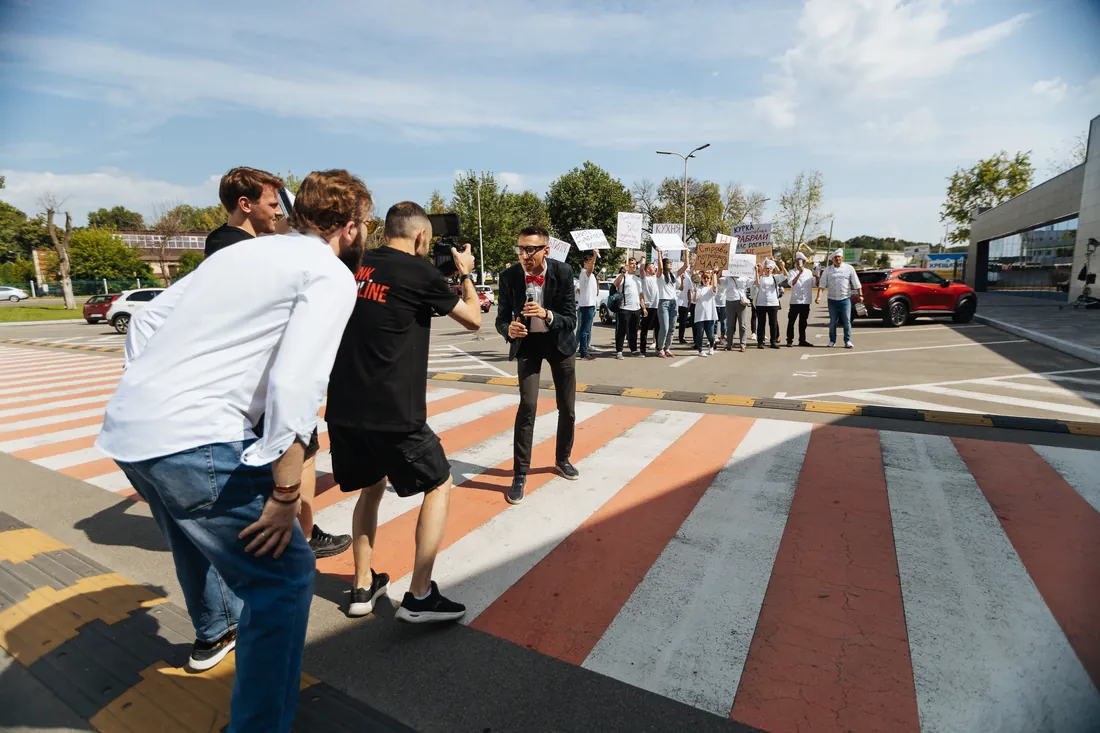 Crew filming a crowd on a pedestrian crossing