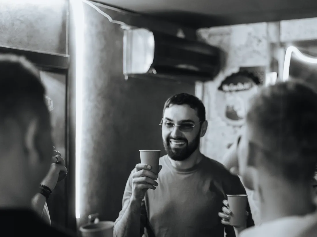 Guests with cups, black and white