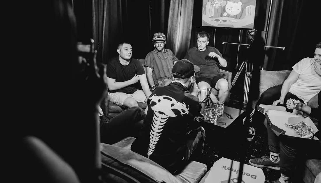 Guests on sofas before a show, black and white