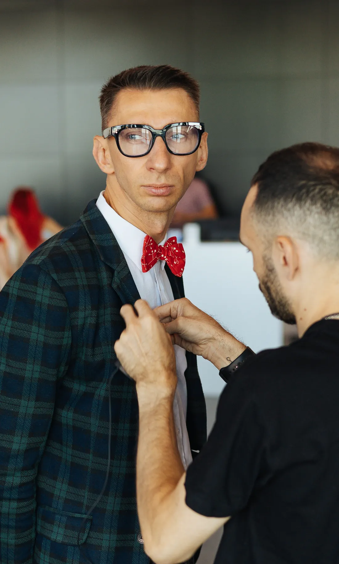 Adjusting a bow tie before a take