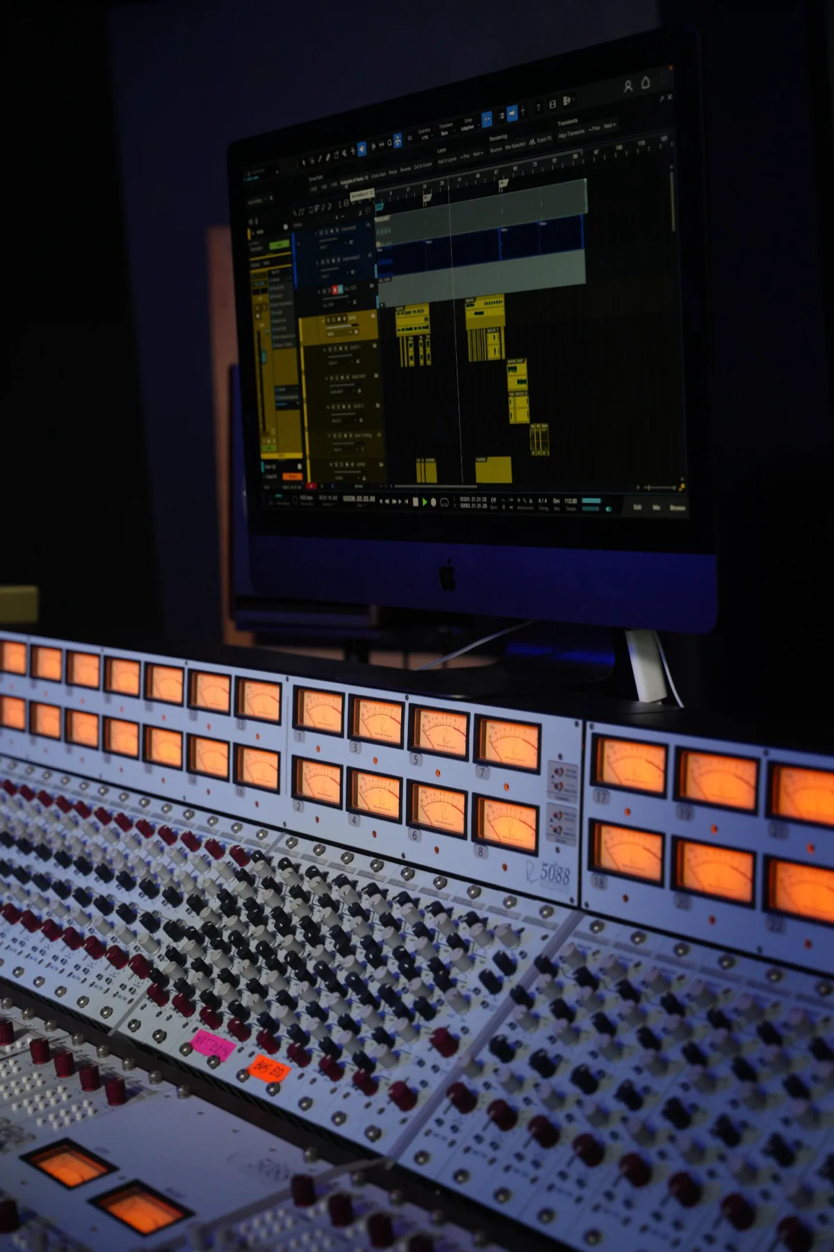 Console with VU meters and a session on the monitor